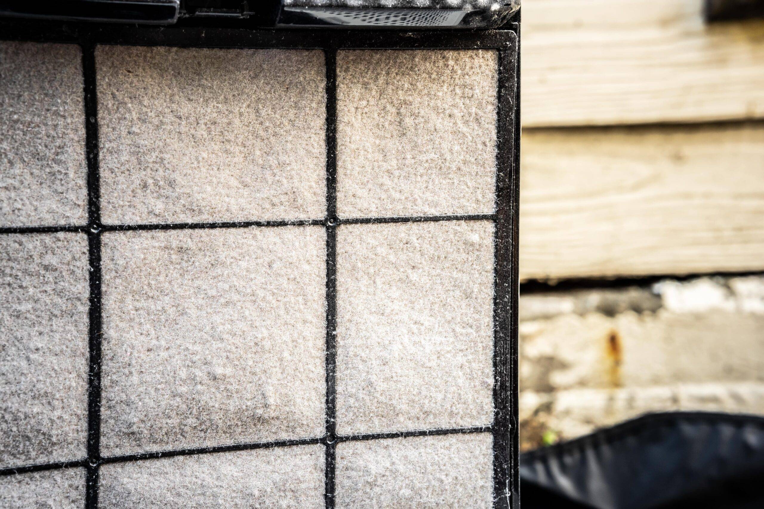 An HVAC filter that's covered in dust.