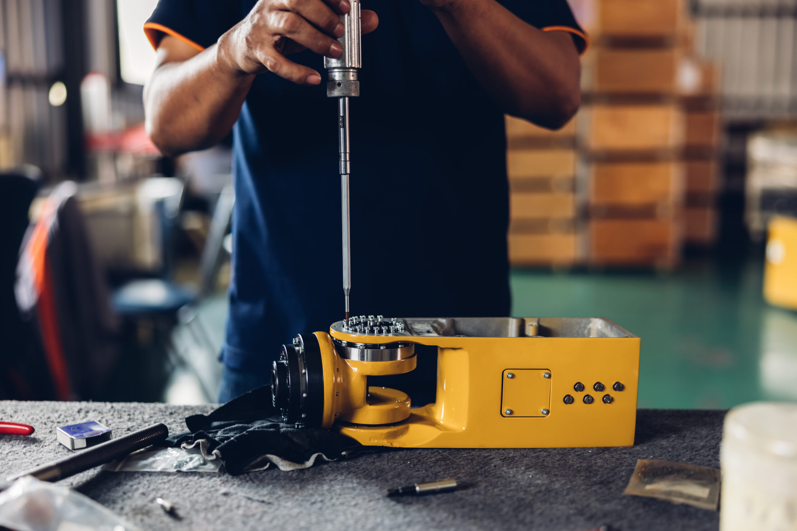 A man repairing a large power tool.