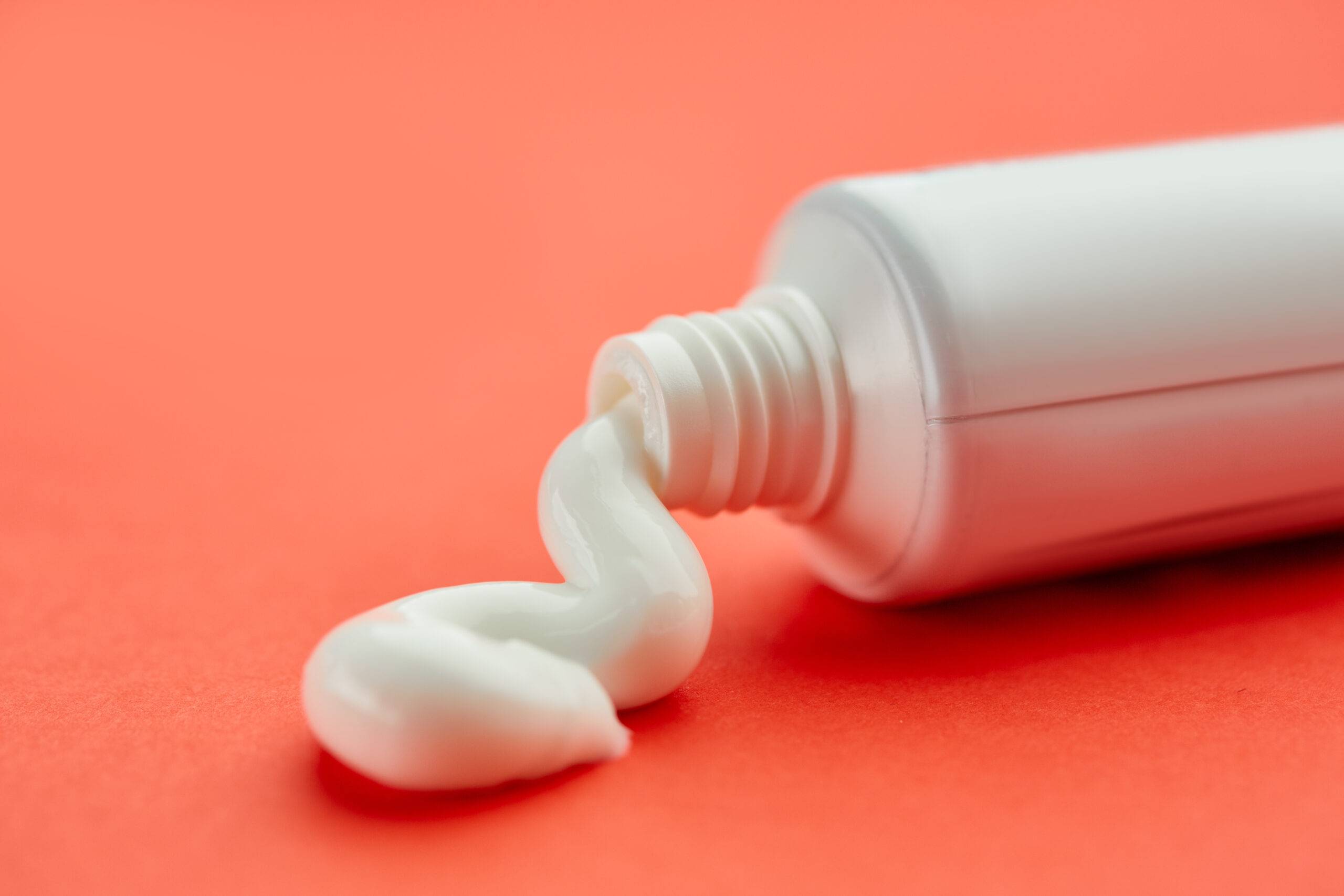 Oral care products, red background, nobody. Morning healthcare procedures concept, toothcare, toothbrush and toothpaste