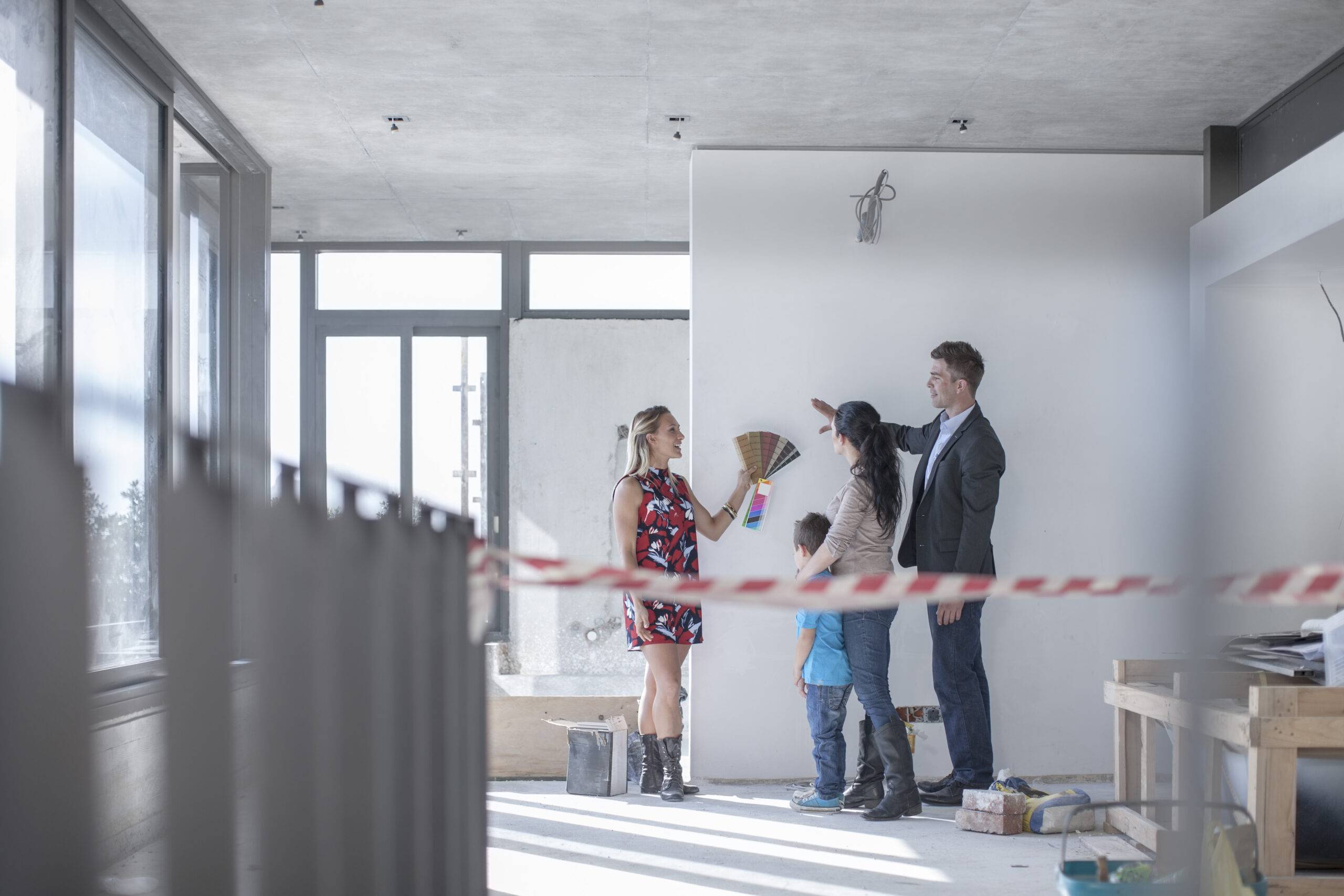 Woman with color sample and family in building shell