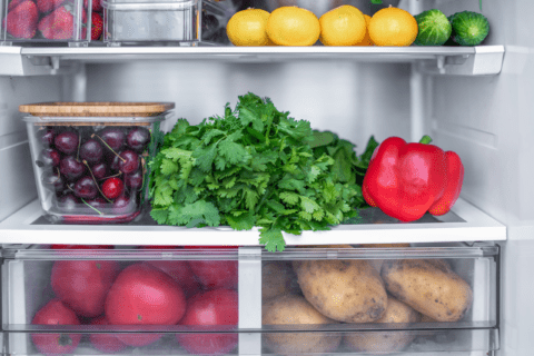 Fridge with potatoes in the drawer.
