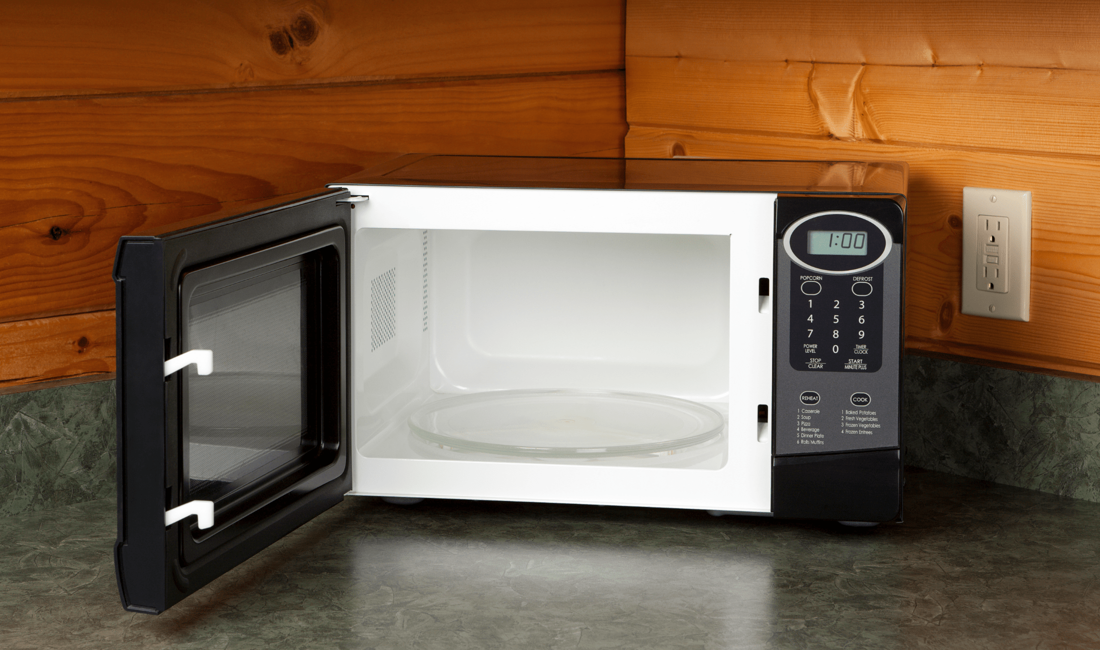 An open microwave on a counter.