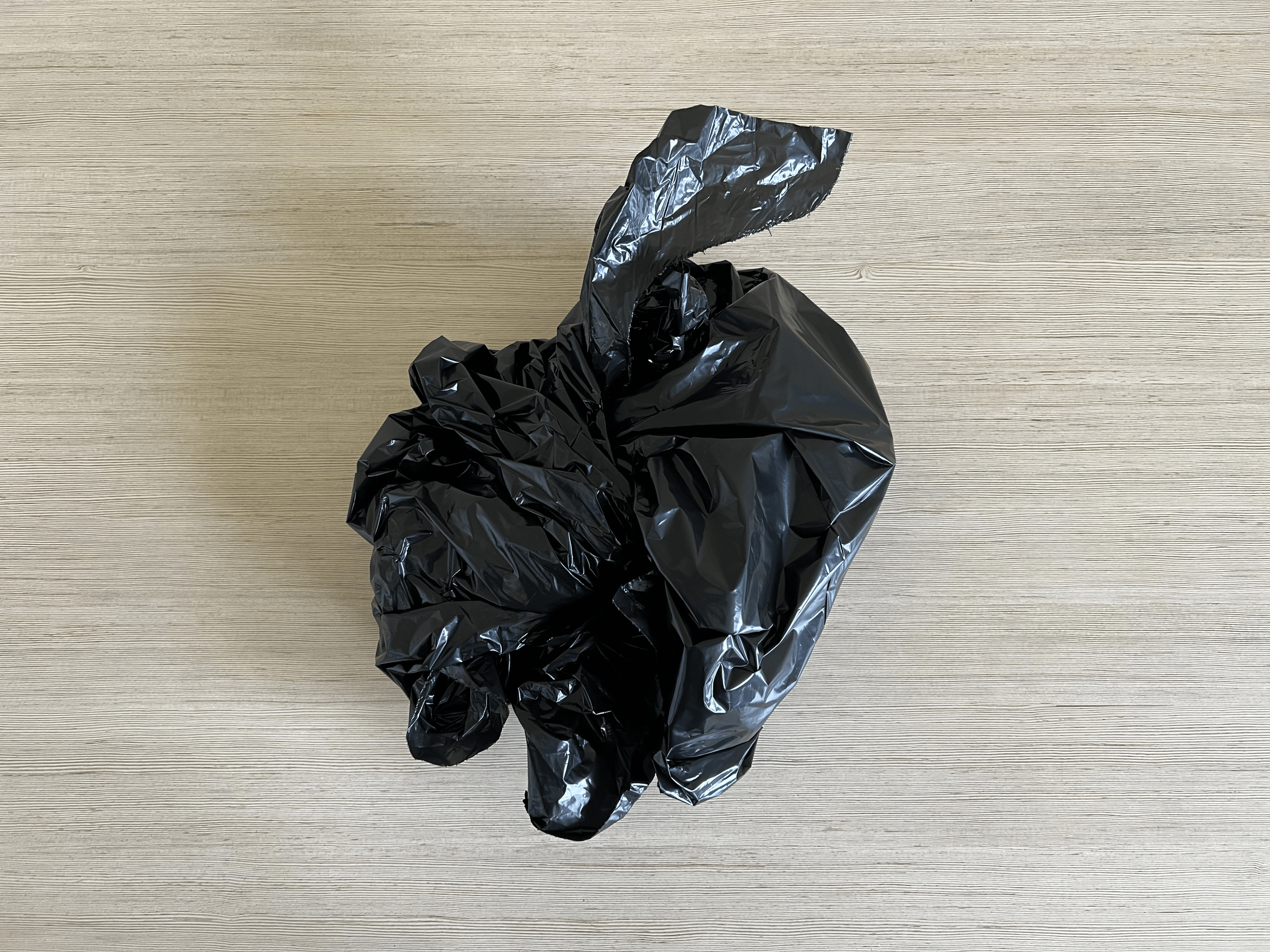 A garbage bag seem from above that's tied up on top.