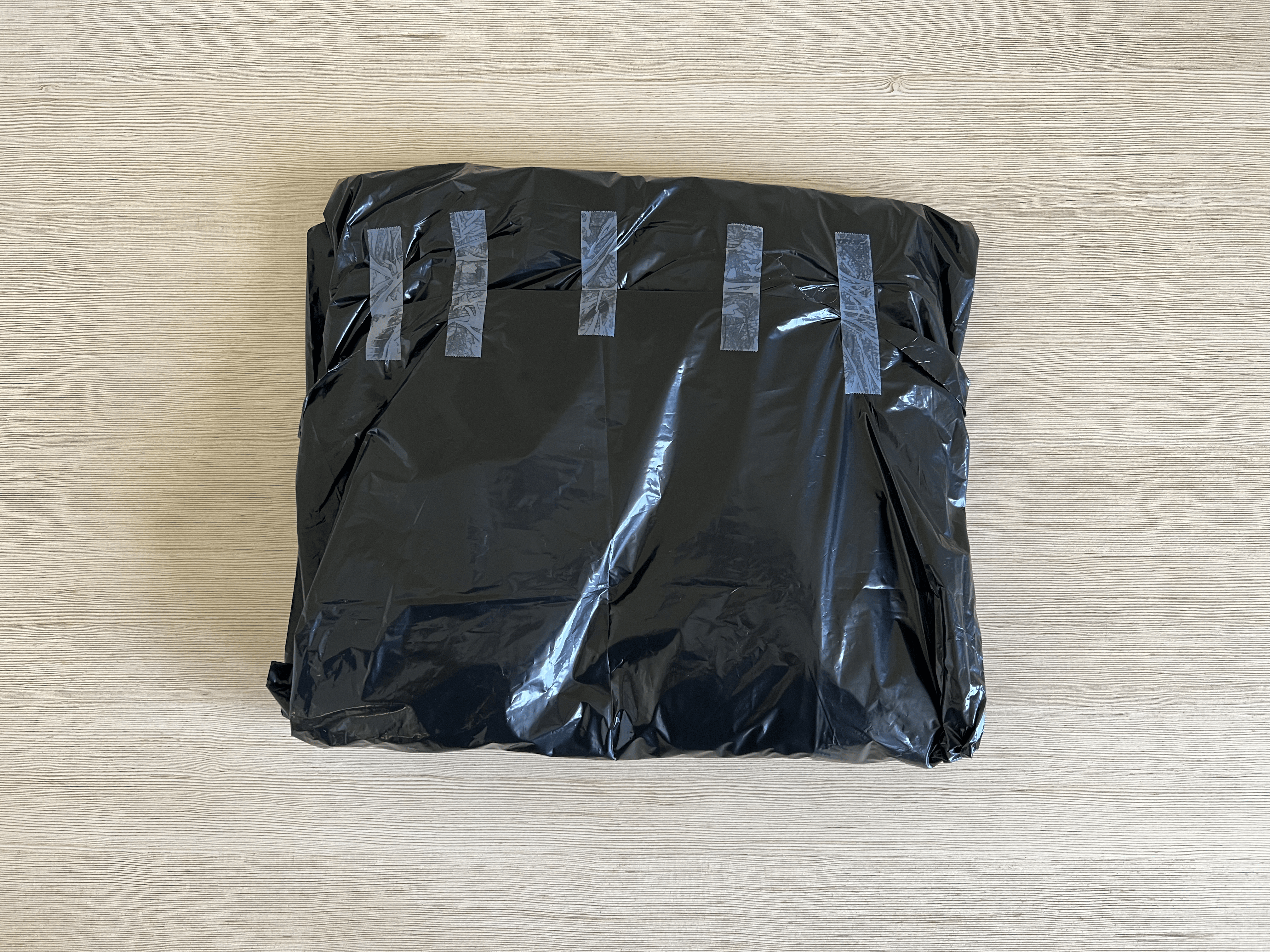 A folded up garbage bag taped together.