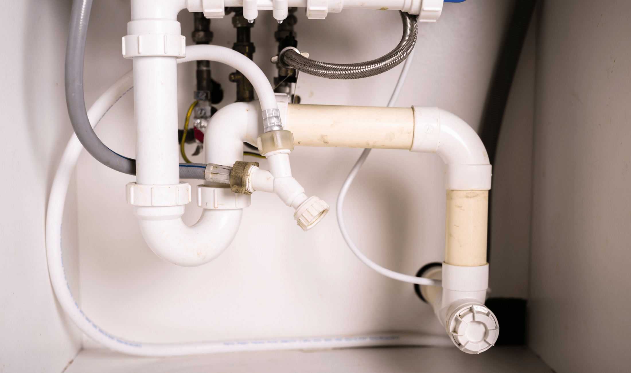 A view of the under-sink plumping of a sink.