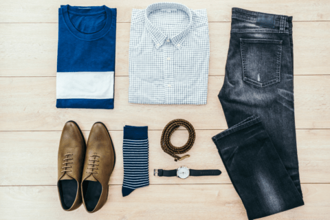 flatlay overhead shot of men's shoes, belt, watch, socks, pants and shirt
